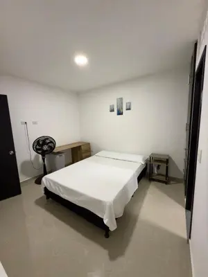 a bedroom with a bed in a white room at Estrena confortable casa in Mariquita