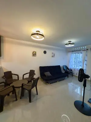 a living room with a blue couch and chairs at Estrena confortable casa in Mariquita
