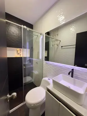 a bathroom with a toilet and a sink and a shower at Estrena confortable casa in Mariquita