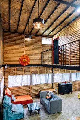 a living room with two couches and a balcony at Mágica Cabaña con jacuzzi en Santa Elena in Santa Elena