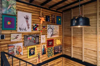a room with a wooden wall with pictures on it at Mágica Cabaña con jacuzzi en Santa Elena in Santa Elena