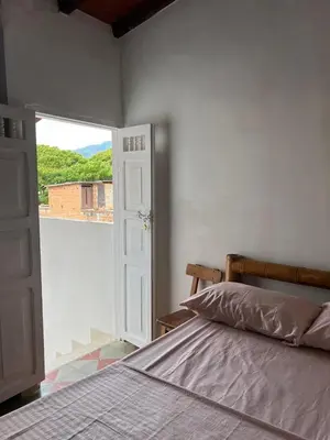 a bedroom with a bed and an open door at Famihotel Asturias in Hispania