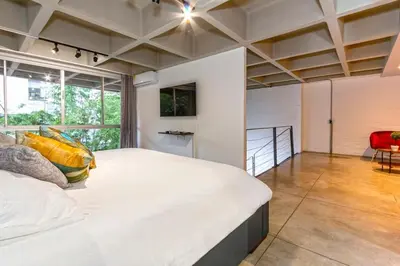 a bedroom with a large bed and a large window at Astorga loft by Host Medellin in Medellín