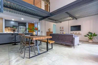 a kitchen and living room with a table and a couch at Astorga loft by Host Medellin in Medellín