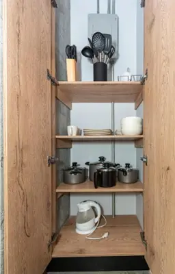 a wooden cabinet with pots and pans on it at Astorga loft by Host Medellin in Medellín