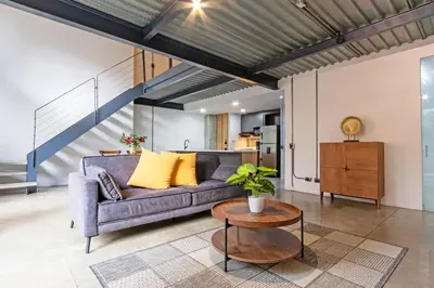 a living room with a couch and a table at Astorga loft by Host Medellin in Medellín