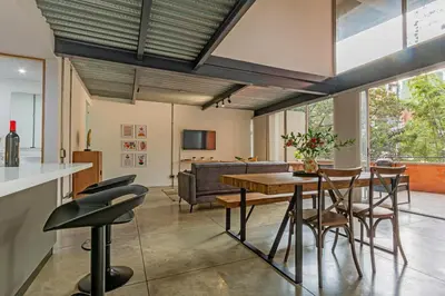 a kitchen and living room with a table and chairs at Astorga loft by Host Medellin in Medellín