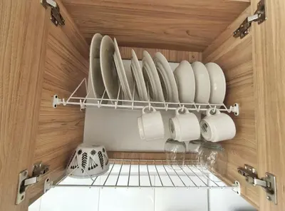 a cupboard filled with white plates and cups at Apartaestudio S201 a 2 calles Milán Urbanevo in Manizales
