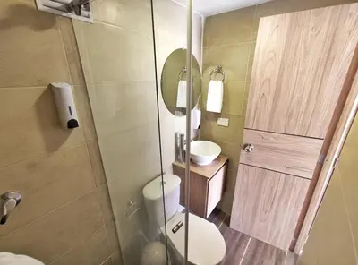 a bathroom with a shower and a toilet and a sink at Apartaestudio S201 a 2 calles Milán Urbanevo in Manizales
