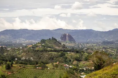 a view of a mountain with a rock in the background at Luxury Guatapé Loft with Starlink WiFi & Jacuzzi in Chiquinquirá