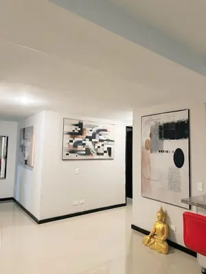 a teddy bear sitting on the floor in an art exhibit at 23rd Floor Luxury Apartment 5 Min from Provenza in Medellín