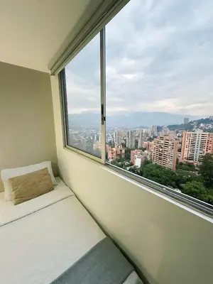 a window seat with a view of a city at 23rd Floor Luxury Apartment 5 Min from Provenza in Medellín