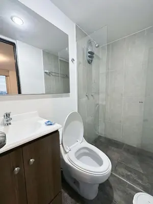 a bathroom with a toilet and a sink and a shower at 23rd Floor Luxury Apartment 5 Min from Provenza in Medellín