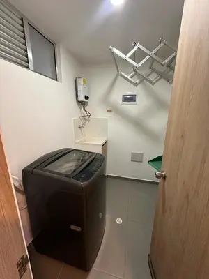 a bathroom with a trash can and a phone at Luxurious and Modern Apartment in Medellín