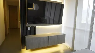 a flat screen tv on a wall in a room at Luxurious and Modern Apartment in Medellín
