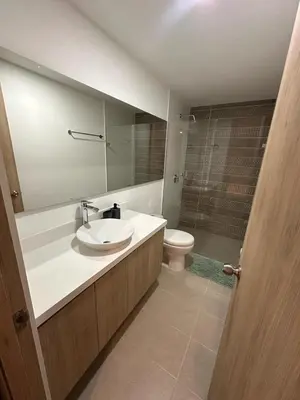a bathroom with a sink and a toilet and a mirror at Luxurious and Modern Apartment in Medellín