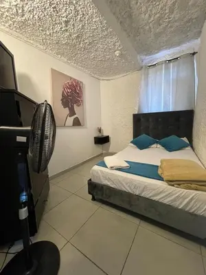 a bedroom with a bed and a television in it at Apartamento cerca al aeropuerto Olaya herrera in Medellín