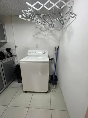 a kitchen with a white stove and a refrigerator at Apartamento cerca al aeropuerto Olaya herrera in Medellín