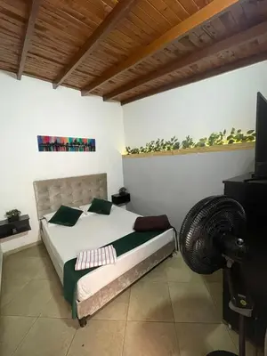 a bedroom with a bed and a flat screen tv at Apartamento cerca al aeropuerto Olaya herrera in Medellín
