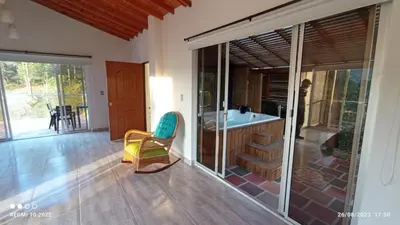 a bathroom with a tub and a chair in a room at Villa Maru in El Peñol