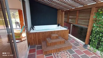 a large bath tub in a room with a patio at Villa Maru in El Peñol