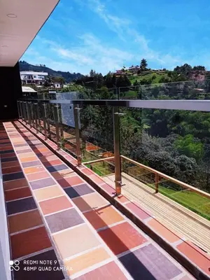 a balcony with a view of the mountains at Villa Maru in El Peñol