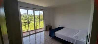 a bedroom with a bed and a large window at Villa Maru in El Peñol