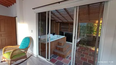 a bathroom with a tub and a glass window at Villa Maru in El Peñol