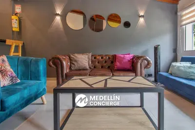 a living room with a couch and a table at 2BR House Jacuzzi & AC in Poblado Manila in Medellín