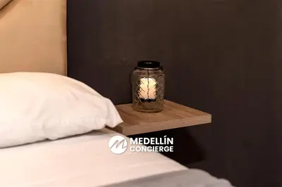 a jar on a night stand next to a bed at 2BR House Jacuzzi & AC in Poblado Manila in Medellín