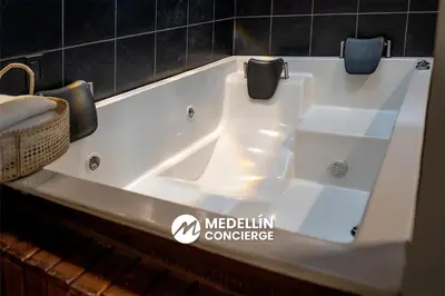 a white bath tub in a bathroom at 2BR House Jacuzzi & AC in Poblado Manila in Medellín