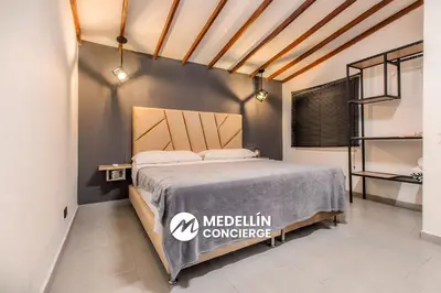 a bedroom with a bed with a medlinurance bedspread at 2BR House Jacuzzi & AC in Poblado Manila in Medellín