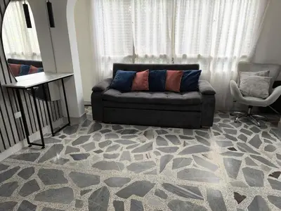 a living room with a couch and a chair at Hermoso Apto Cerca centro comercial Molinos in Medellín