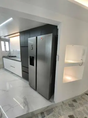 a kitchen with a stainless steel refrigerator in a room at Hermoso Apto Cerca centro comercial Molinos in Medellín