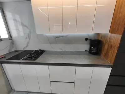 a white kitchen with a stove and white cabinets at Hermoso Apto Cerca centro comercial Molinos in Medellín