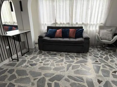 a living room with a couch and a chair at Hermoso Apto Cerca centro comercial Molinos in Medellín