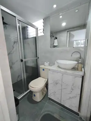 a bathroom with a toilet and a sink and a shower at Hermoso Apto Cerca centro comercial Molinos in Medellín