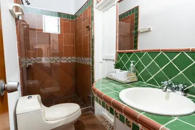 a bathroom with a toilet and a sink and a shower at Villa Armonía - Santa Fé de Antioquia in Santa Fe de Antioquia