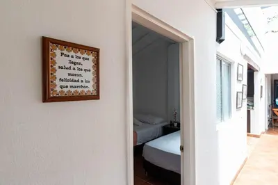 a bedroom with a bed and a picture on the wall at Villa Armonía - Santa Fé de Antioquia in Santa Fe de Antioquia