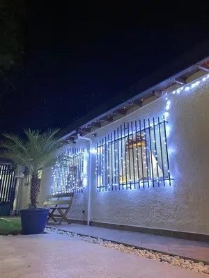 a white building with a window with lights on it at Villa Armonía - Santa Fé de Antioquia in Santa Fe de Antioquia