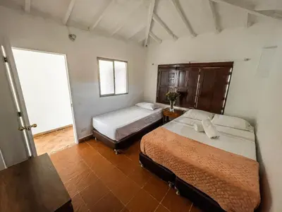 a bedroom with two beds and a window at Villa Armonía - Santa Fé de Antioquia in Santa Fe de Antioquia