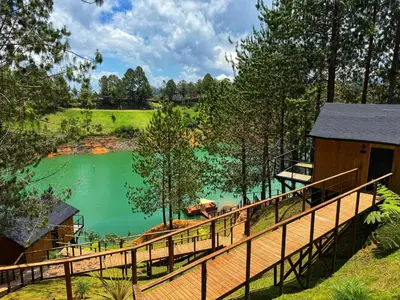 a view of a lake from the deck of a cabin at Cabin - Jacuzzi - Frente al lago - Bosque in La Pradera