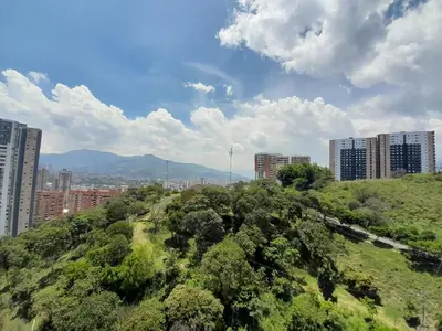 a view of a city with buildings and trees at Superior apto vista campestre in Sabaneta
