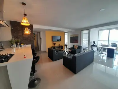 a kitchen and living room with couches and a table at Superior apto vista campestre in Sabaneta