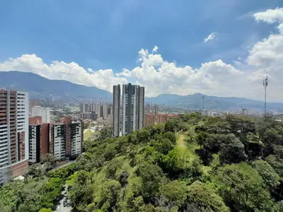 a view of a city with buildings and trees at Superior apto vista campestre in Sabaneta