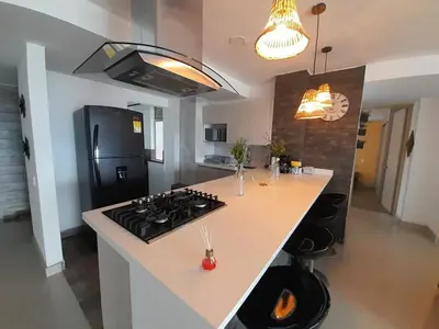 a kitchen with a stove and a counter top at Superior apto vista campestre in Sabaneta