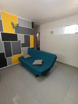 a living room with a blue couch in a room at S21 COMODO APARTAMENTO EN LAURELES ESTADIo 2 HABT 2 BAÑOS in Medellín