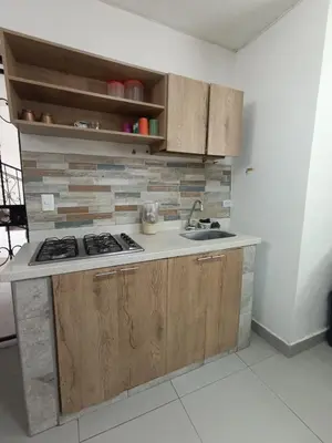 a kitchen with a sink and a stove in it at S21 COMODO APARTAMENTO EN LAURELES ESTADIo 2 HABT 2 BAÑOS in Medellín