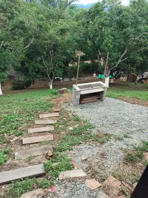 a park with a bench and some rocks and trees at Encanto colonial in Sopetran