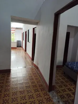 a hallway with a room with a bed and a tile floor at Encanto colonial in Sopetran